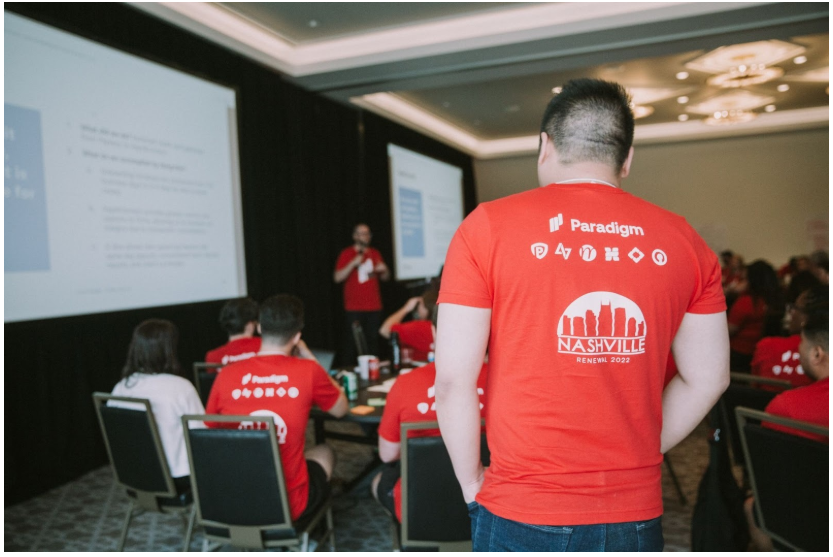 Paradigm team event with a presentation, attendee in a Paradigm Nashville shirt